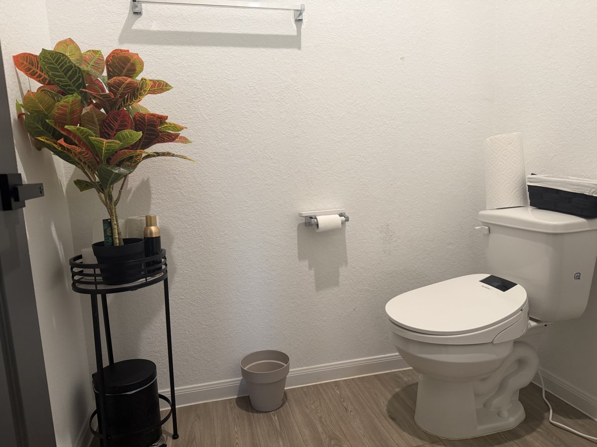 A clean bathroom with a bidet toilet seat
