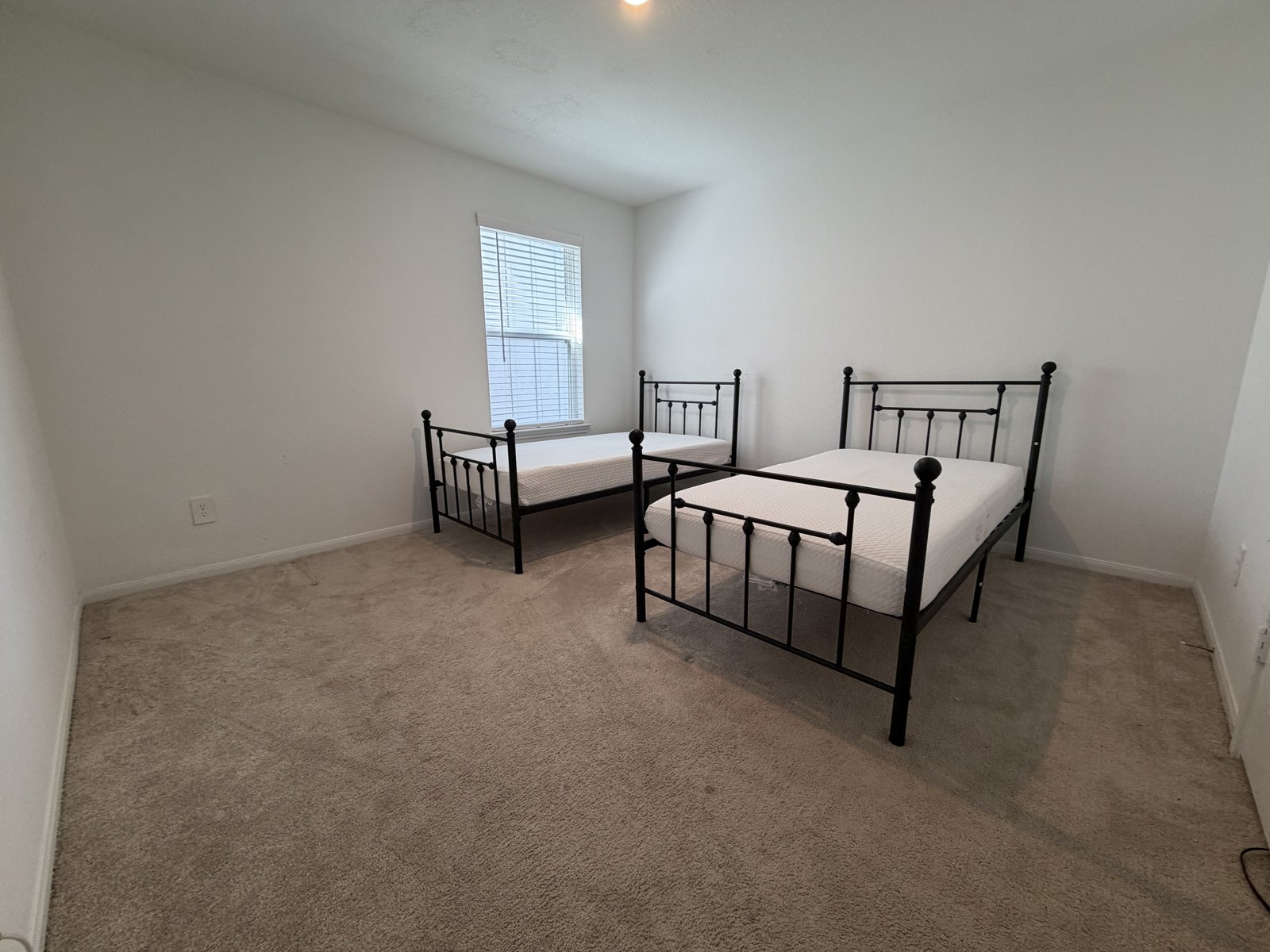 A furnished bedroom with two single beds