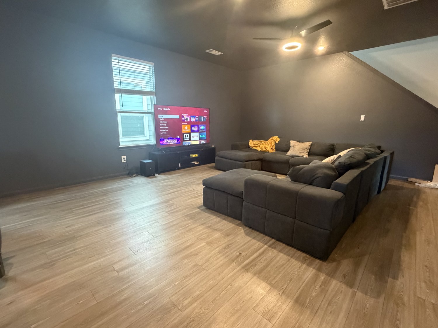 The shared living room with a large sectional couch and television